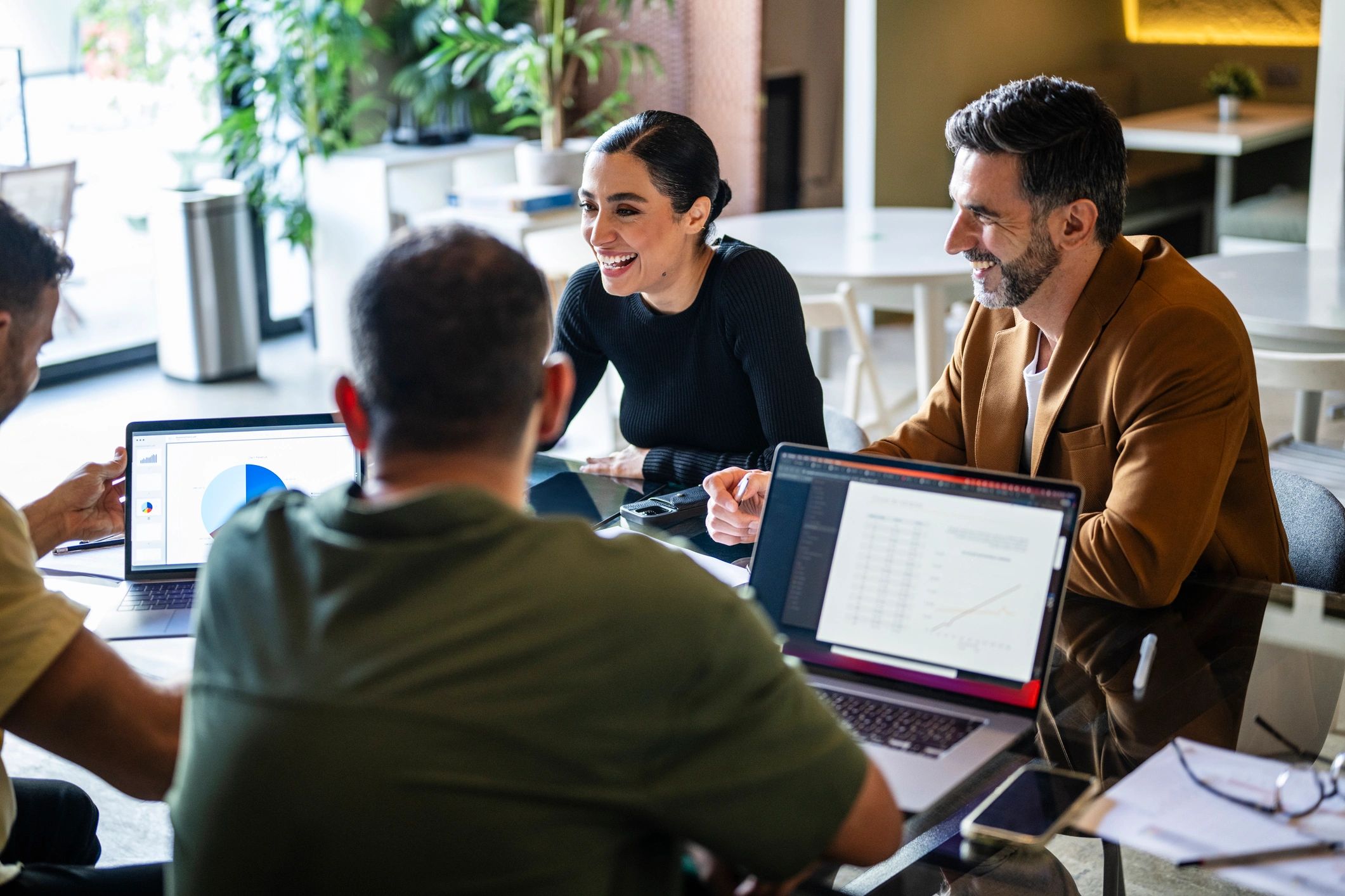 Real estate professionals meeting with clients in a modern office